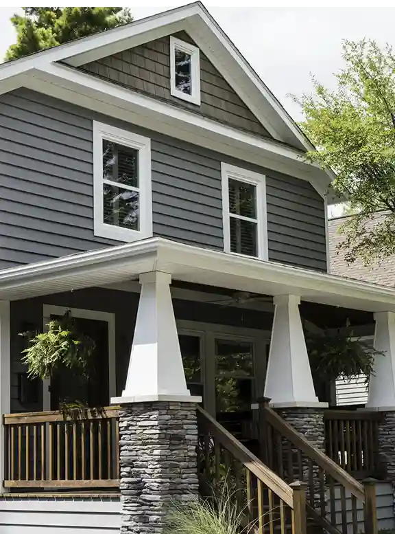 Gray house with porch and front steps.