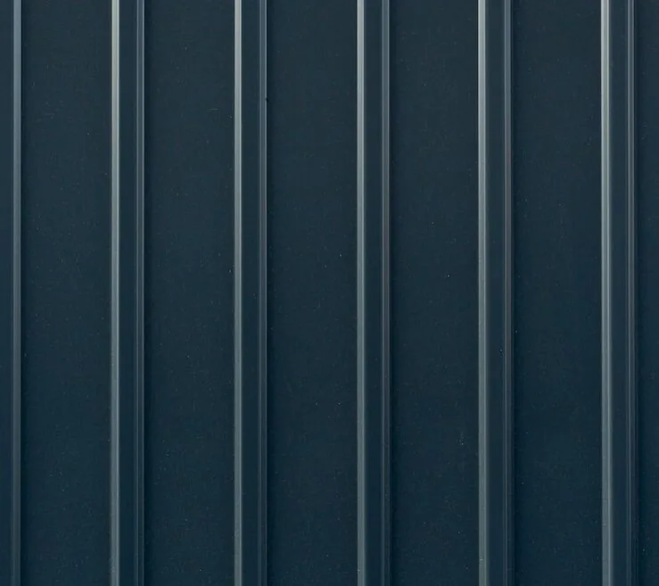 Close up of dark blue commercial steel siding.