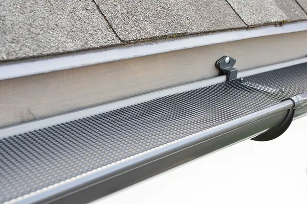 Metal grate covering a gutter on the side.