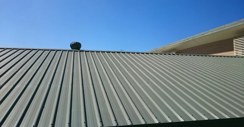 Metal roof against clear blue sky.