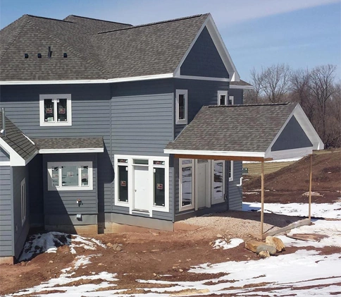 A house with new siding and with grey roof.